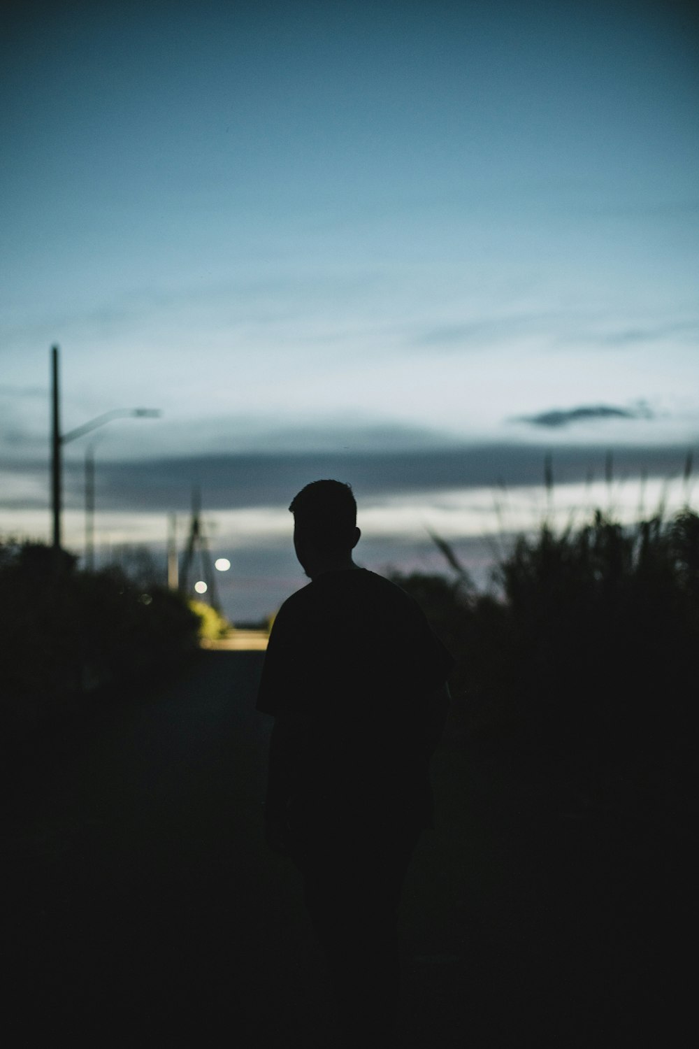 a man walking down a street at night