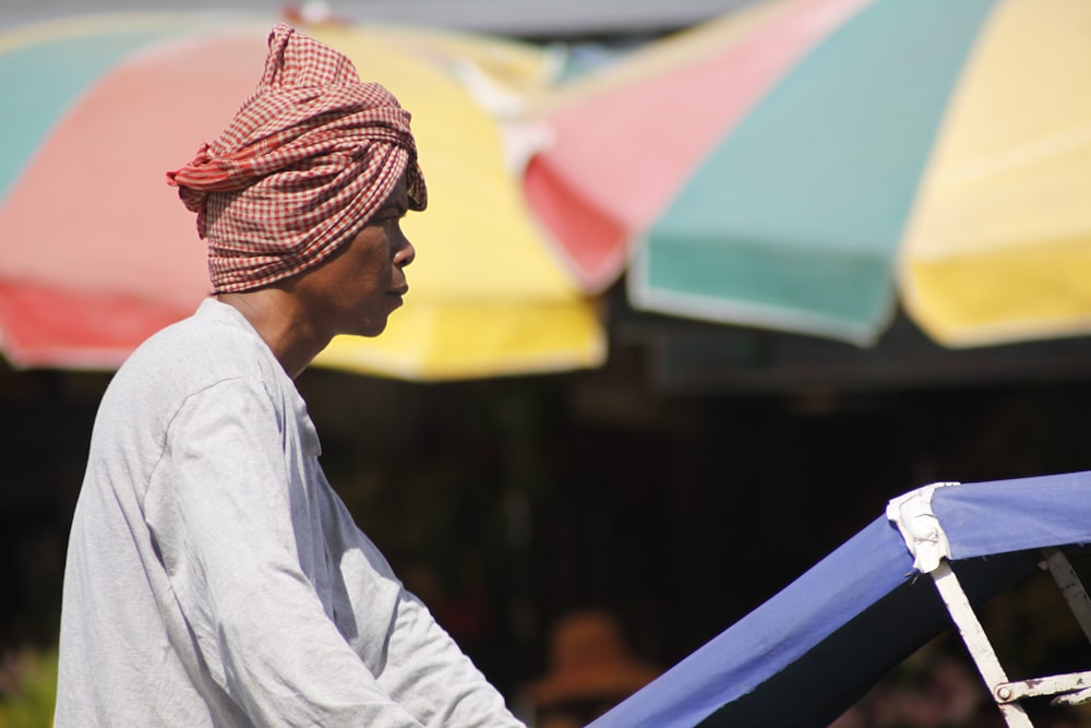 a man in a turban carrying a blue and white stroller