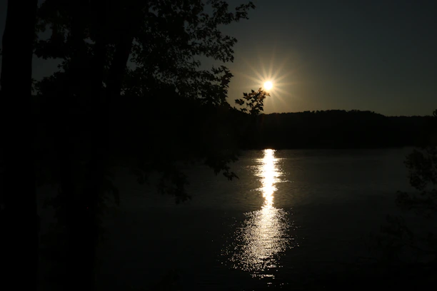 A peaceful sunset over a quiet lake, symbolizing tranquility and balance.
