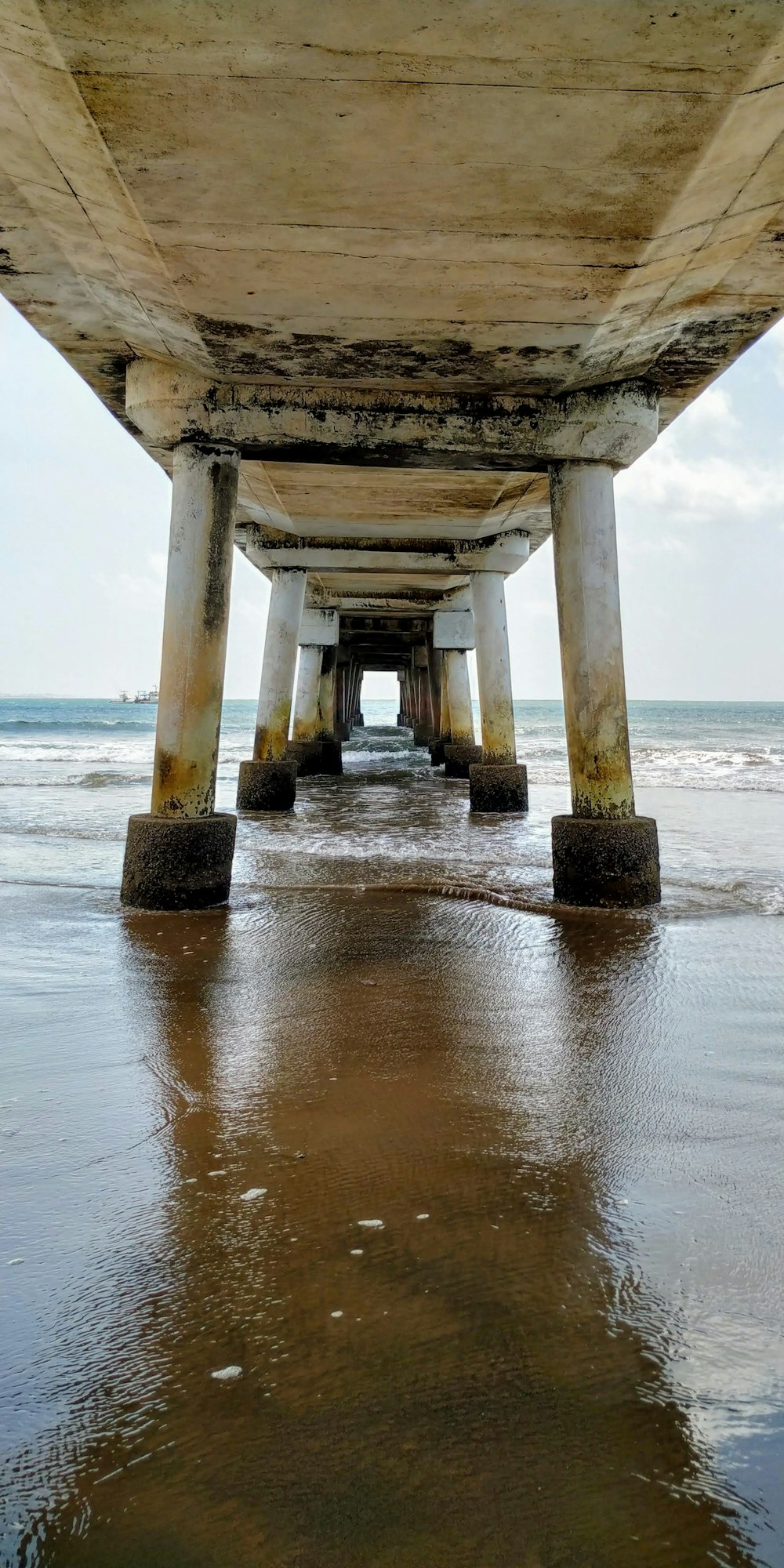 the underside of a bridge over a body of water