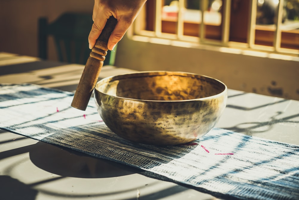 round gold bowl on top of table