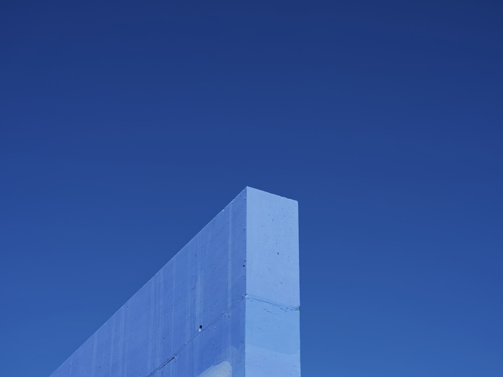 a tall white building sitting under a blue sky