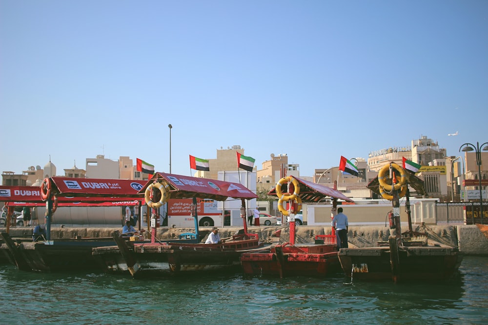 assorted-color boats near buildings during daytime