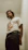 man standing beside white wall