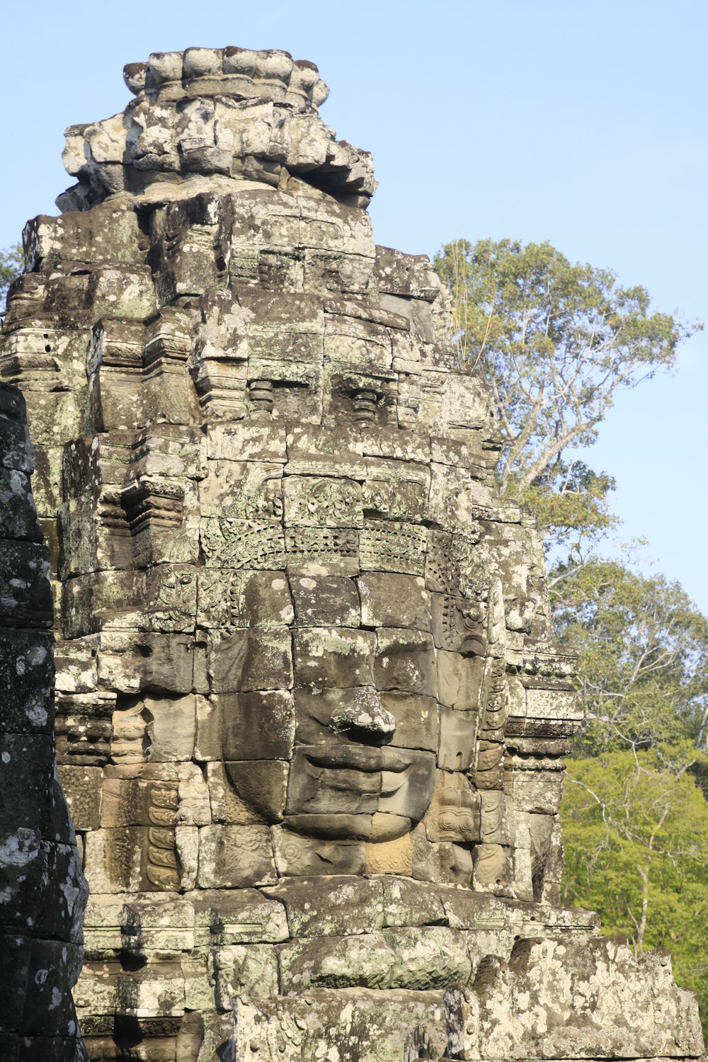 the face of a buddha in a stone temple