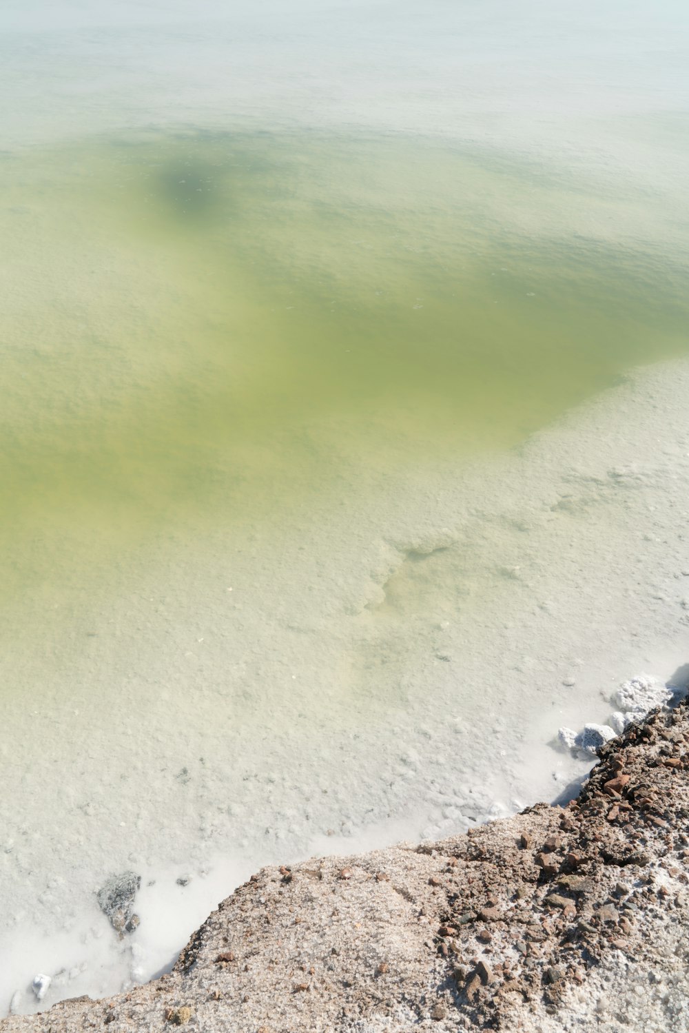 water hitting rocks on shore