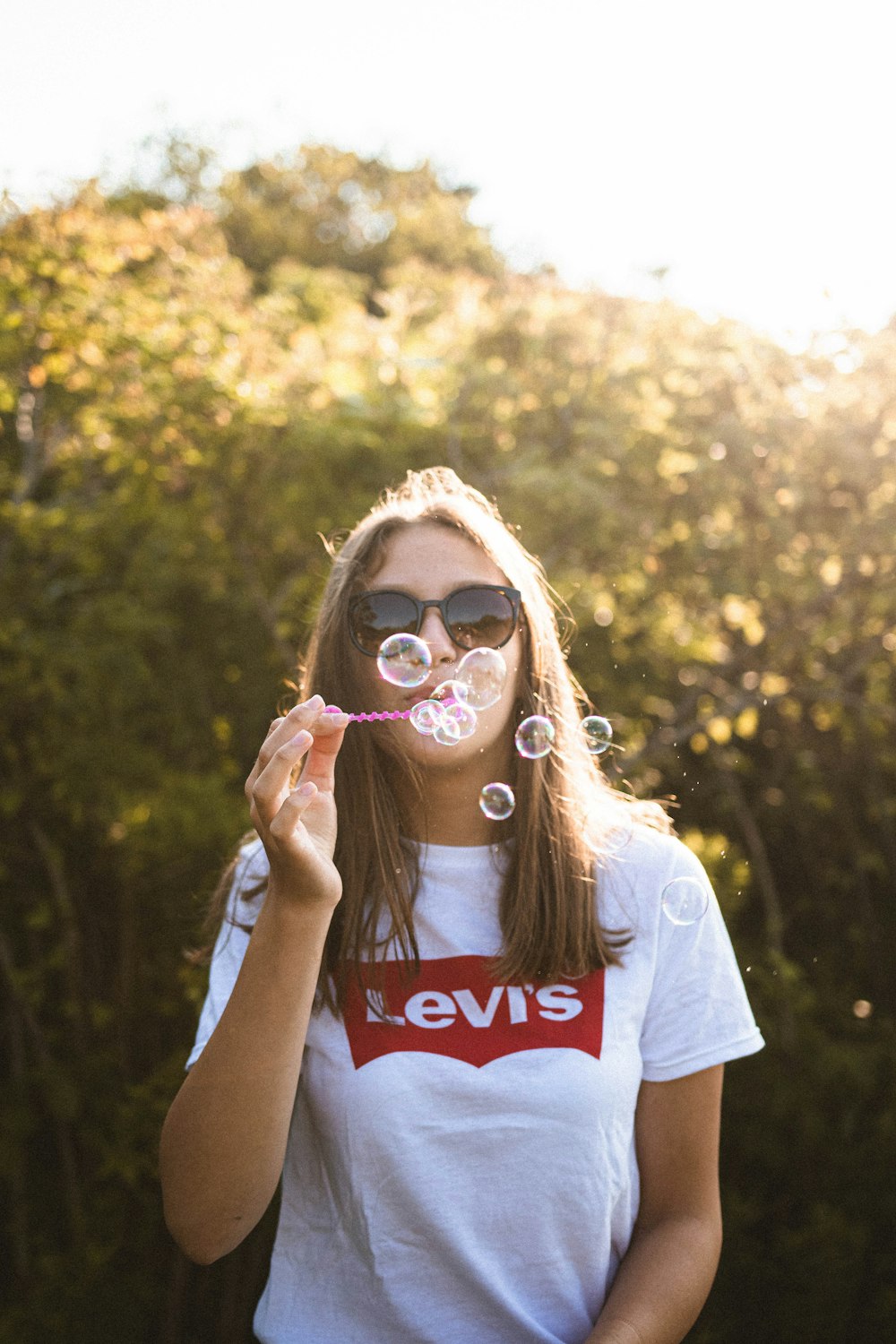 woman blowing bubbles