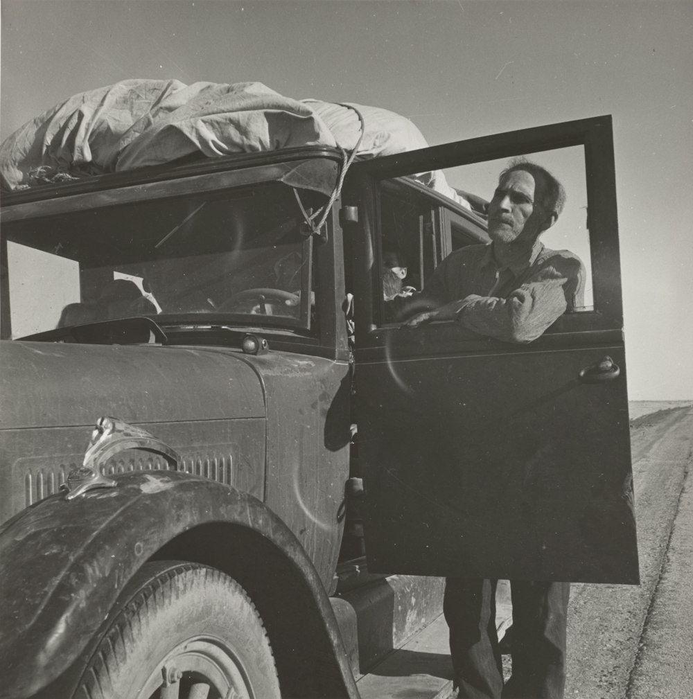 man standing near truck door