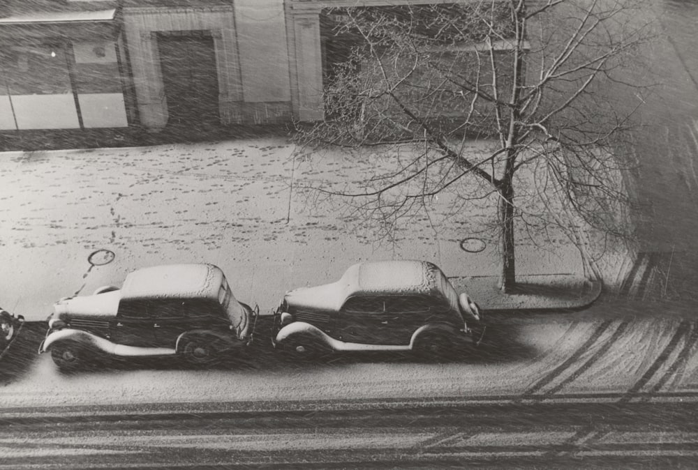 grayscale photography of two vehicles on raod