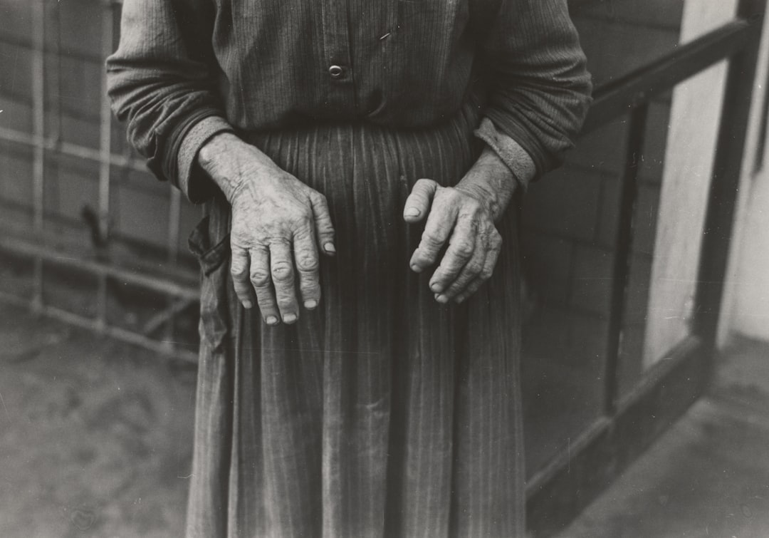 grayscale photography of woman wearing long-sleeved maxi dress