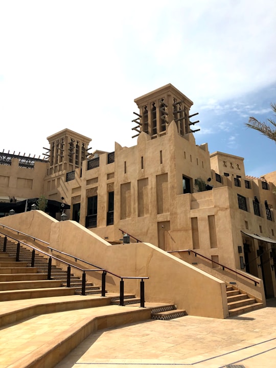 brown concrete building under cloudy sky in Madinat Jumeirah United Arab Emirates