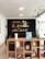A cozy living room featuring custom wood shelving filled with books and decor.