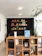 Cozy living room corner featuring a walnut bookshelf filled with books and decor.