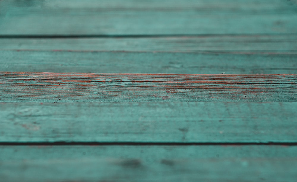 a close up of a wooden surface with a blurry background