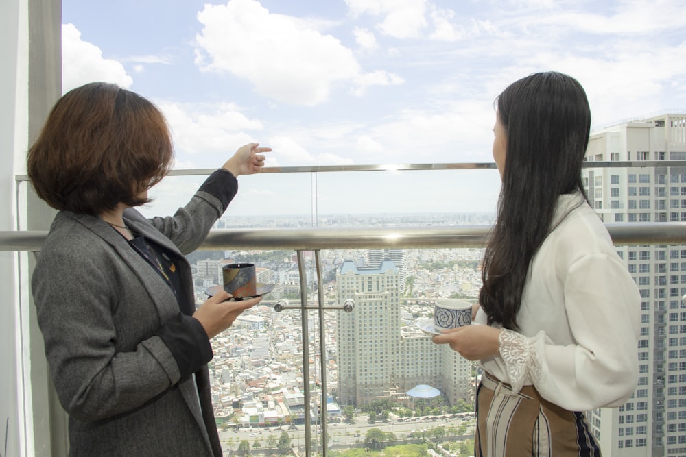 two women standing near buildings during daytime