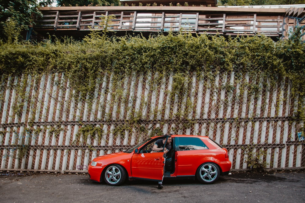 person sitting on red veihcle close-up photography, Audi A3 A premium car