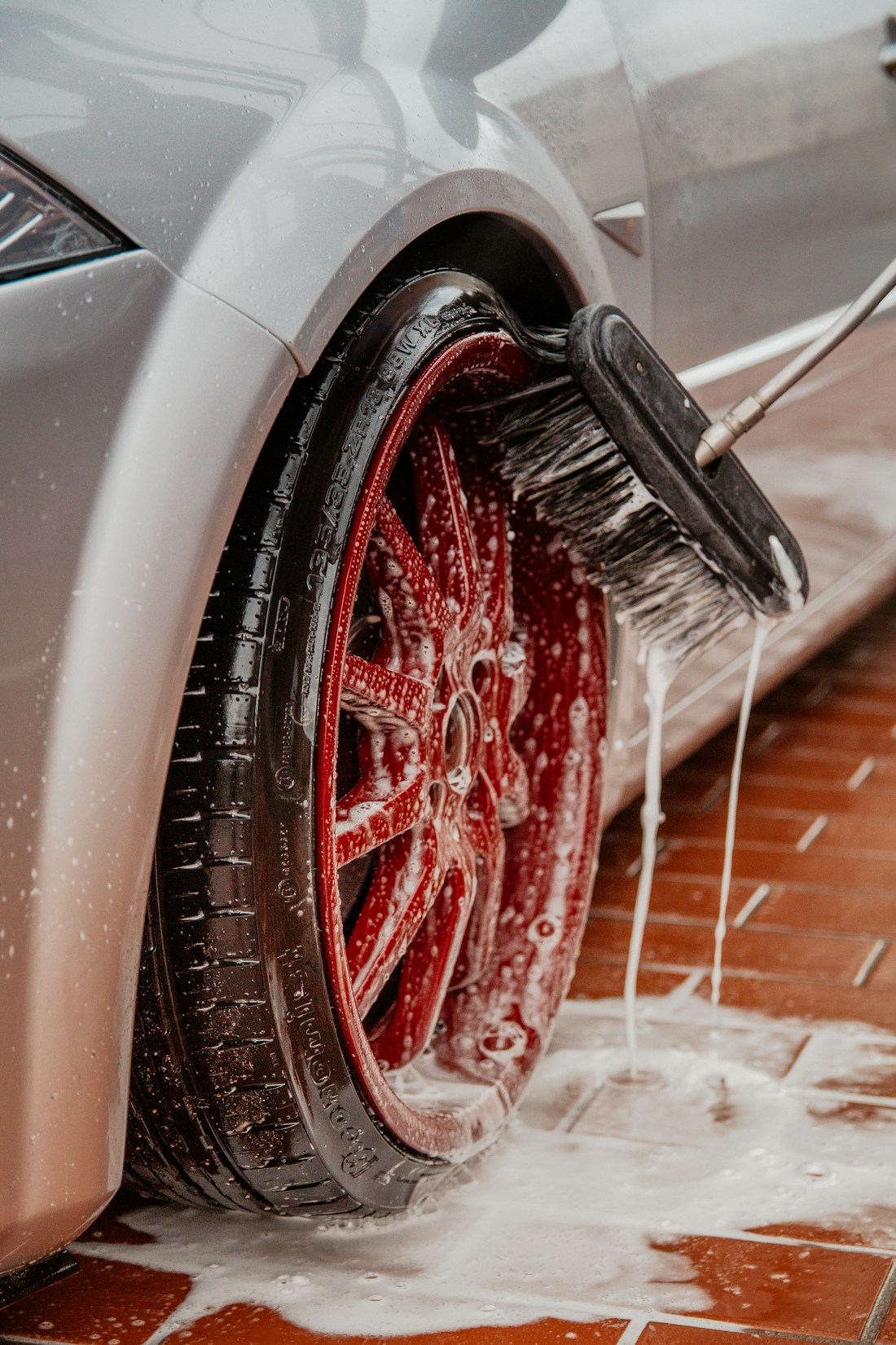 Close-up of a wheel being cleaned during a car wash