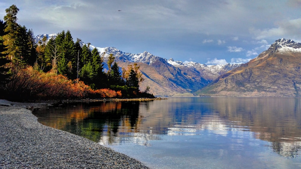 a body of water surrounded by mountains and trees