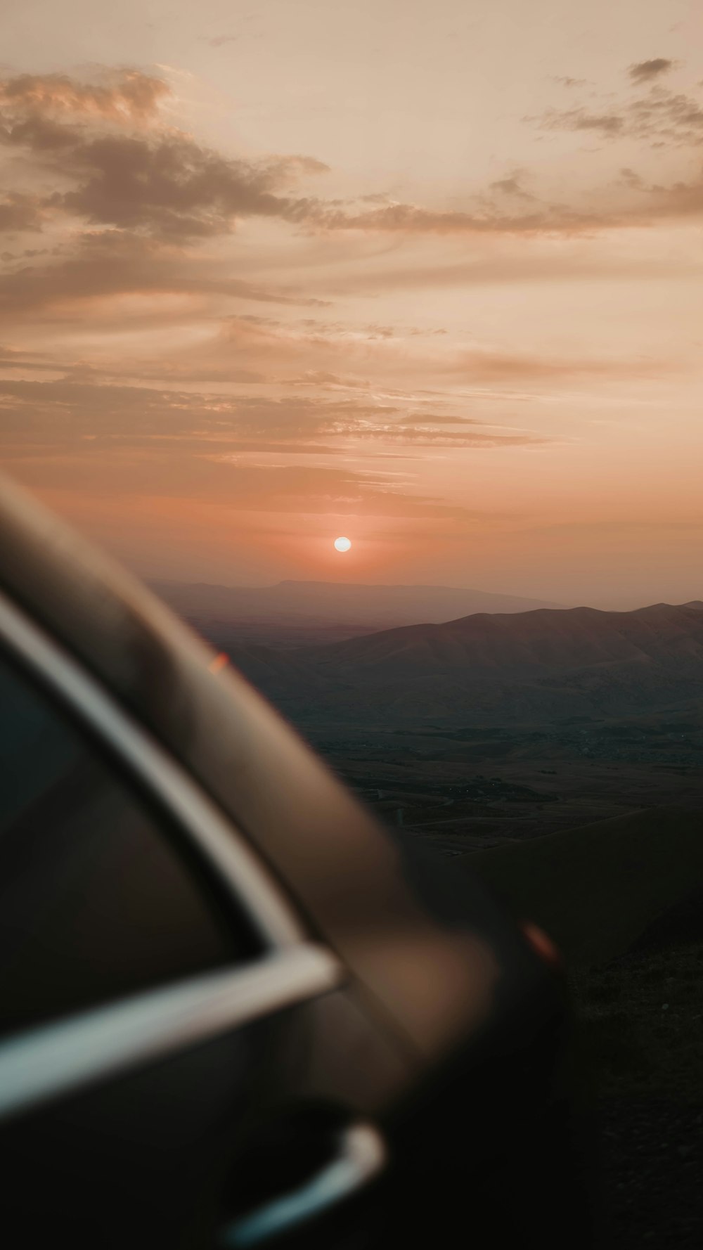 a car driving down a road at sunset