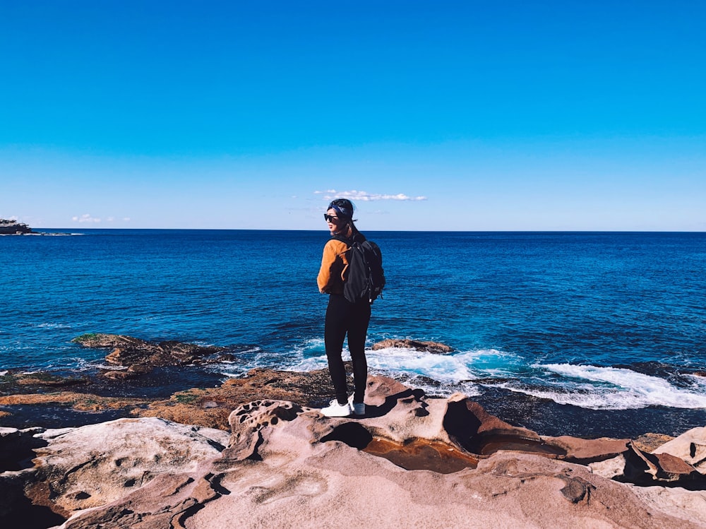 person standing on rock