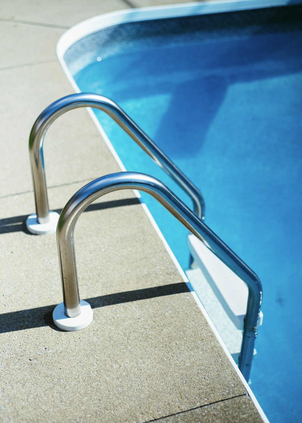 grey and white pool ladder