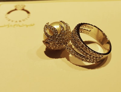 Close-up of a handcrafted gold ring sparkling under soft light.