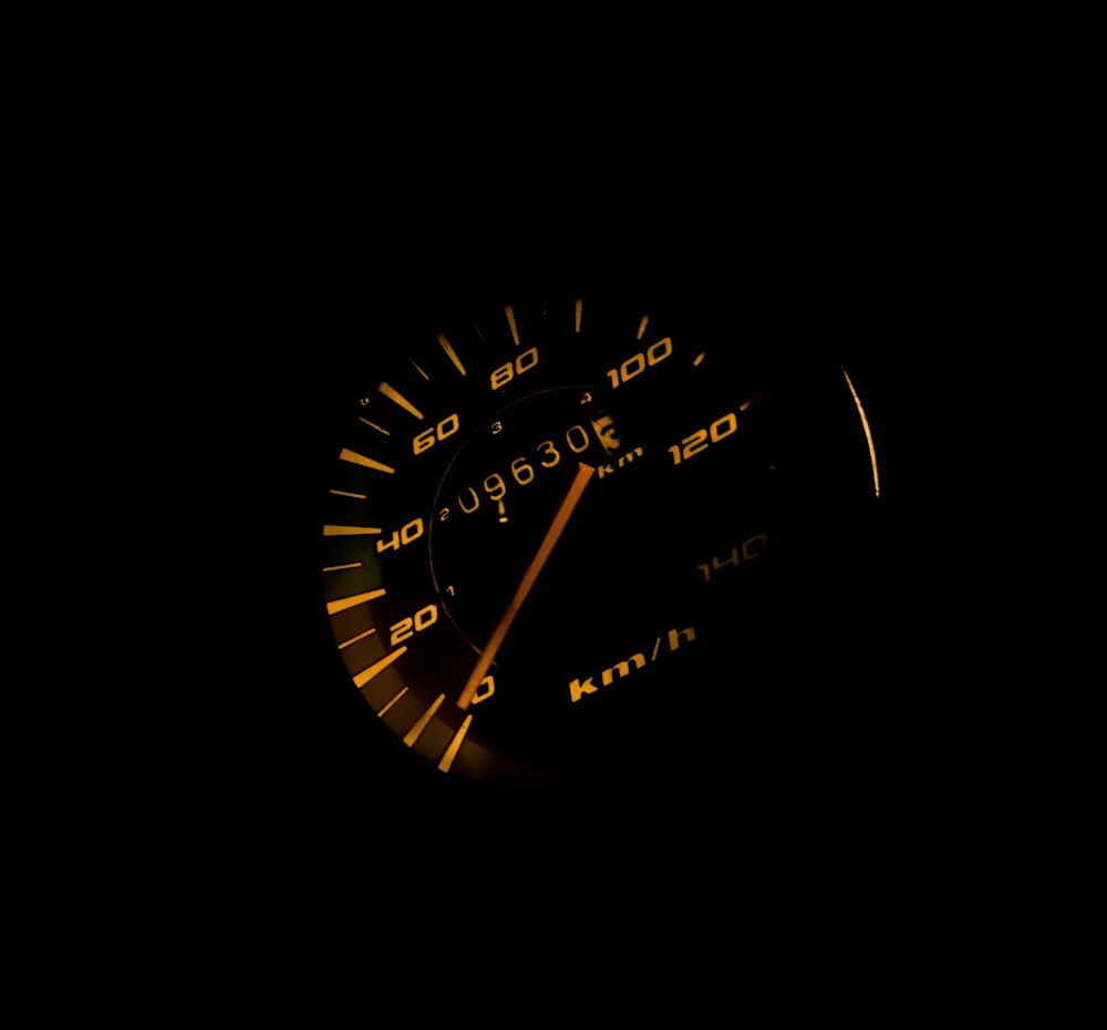 black vehicle speedometer