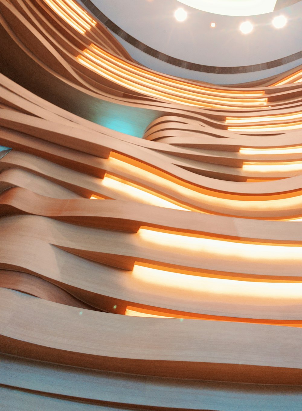 a curved wooden structure with lights on the ceiling