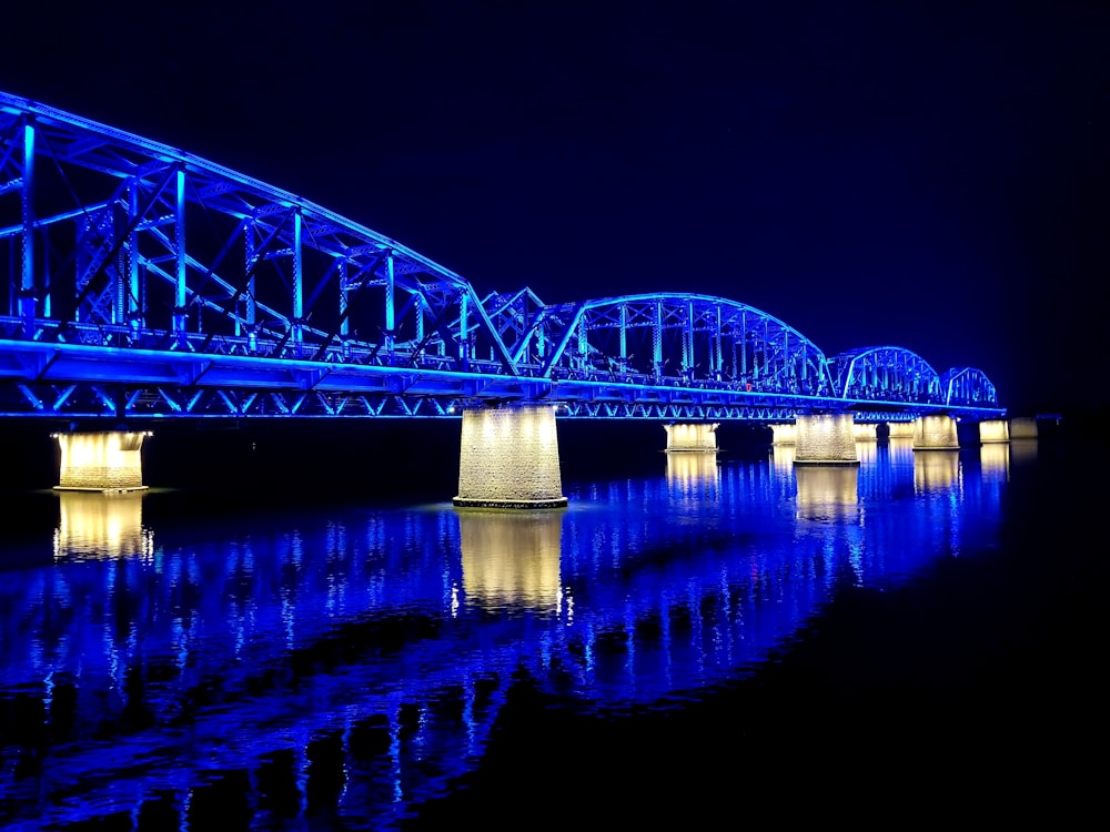 blue lighted bridge view at night