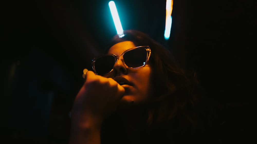 woman wearing sunglasses in dim light