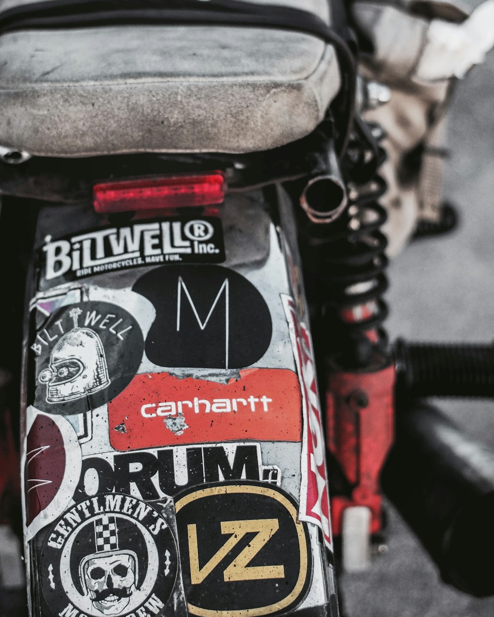 a close up of a motorcycle with stickers on it