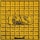 A yellow metal panel with a grid pattern and raised text that reads 'GAS' in the center, surrounded by signs of weathering and dirt.