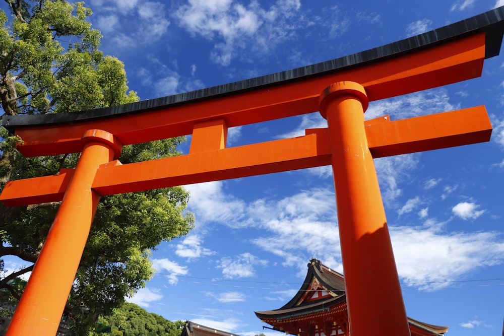 red and black tori gate under blue sky