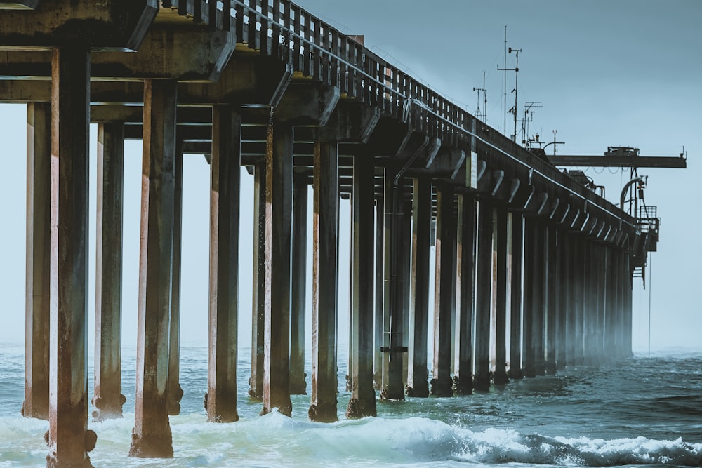 gray concrete bridge viewing sea