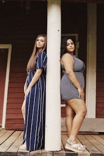 two women leaning on wall