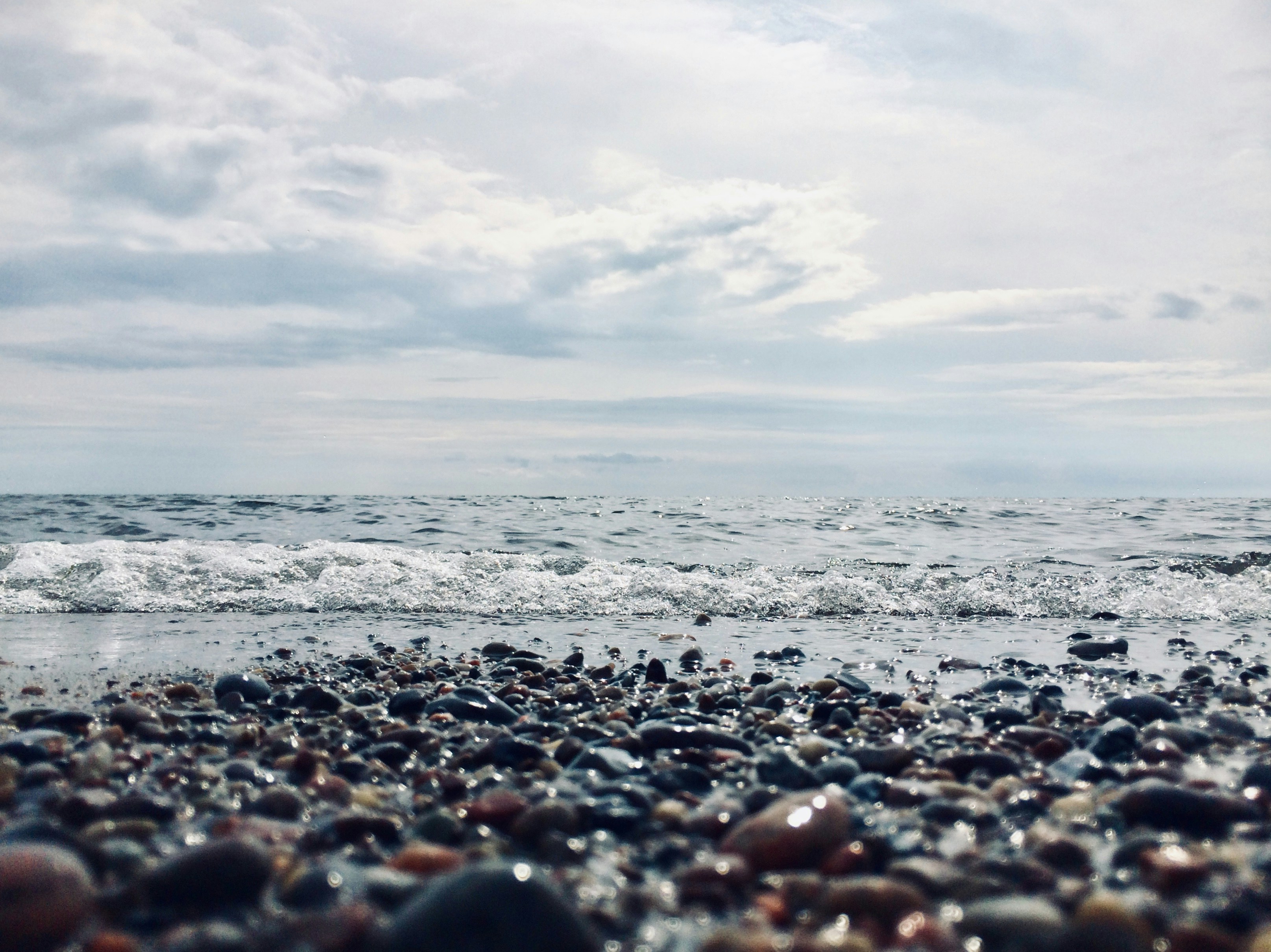 a close up of rocks on a beach near the ocean