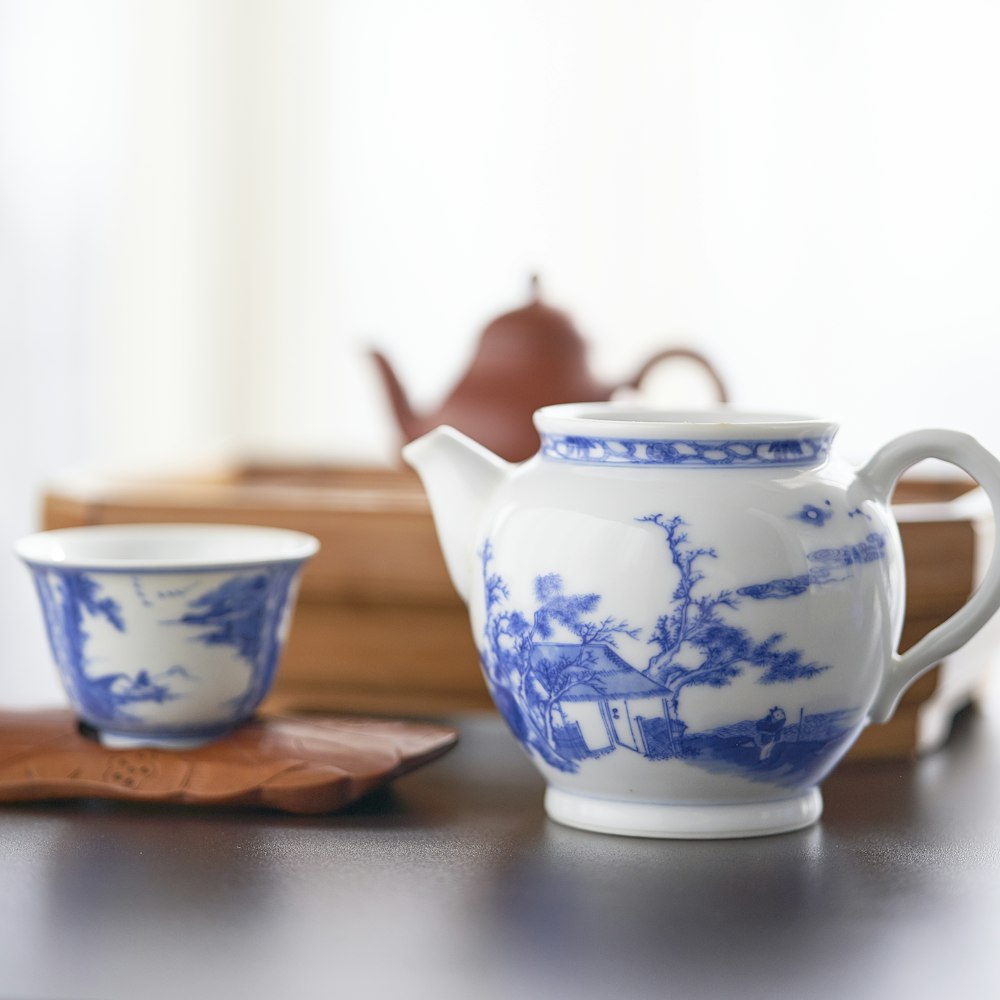 selective focus photography of ceramic teapot and teacup