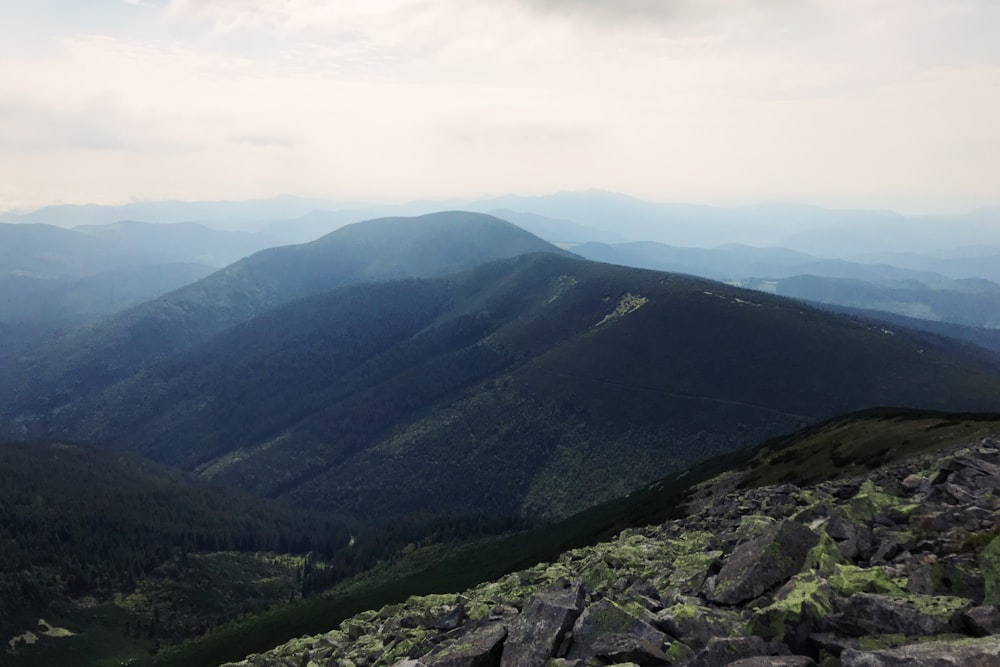 a view of a mountain range from the top of a hill