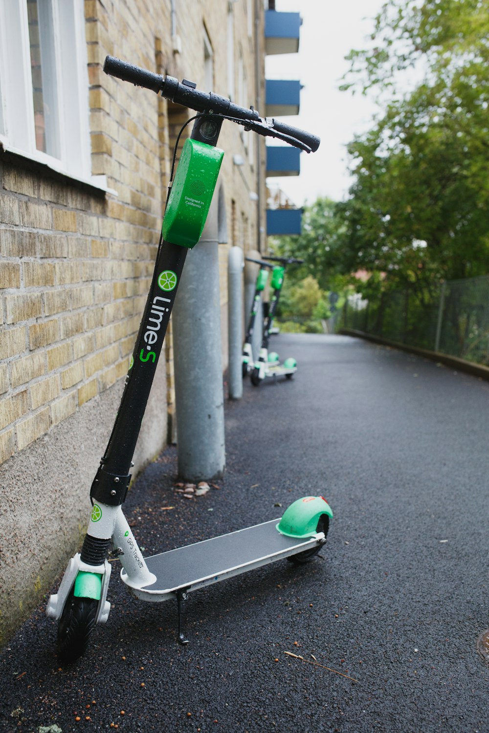 a scooter parked next to a brick building