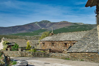 Traditional schist houses nestled in a peaceful mountain village surrounded by nature