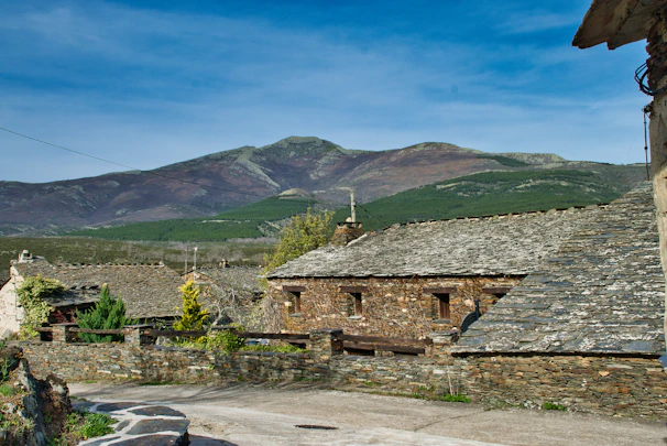 Traditional schist houses nestled in a peaceful mountain village surrounded by nature