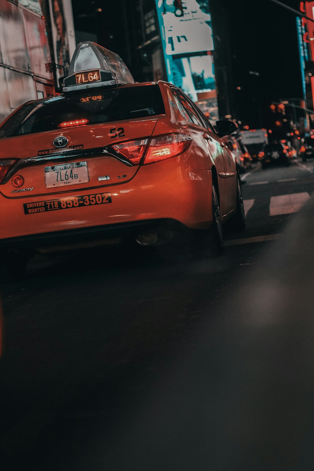 red Toyota sedan on asphalt road