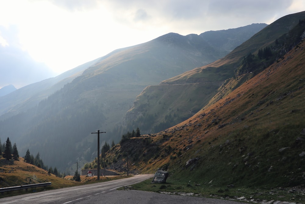 winding road leading to the mountain during daytime