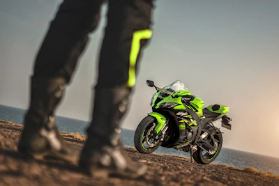 A Honda sportbike speeding along a coastal highway with ocean in the background.
