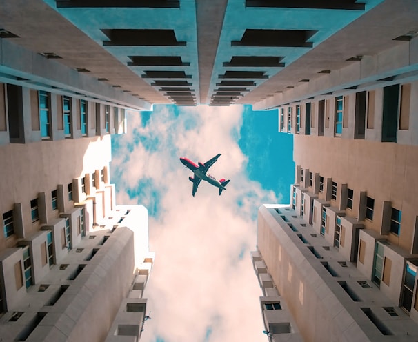 low angle photo of flying gray airliner