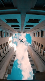 low angle photo of flying gray airliner