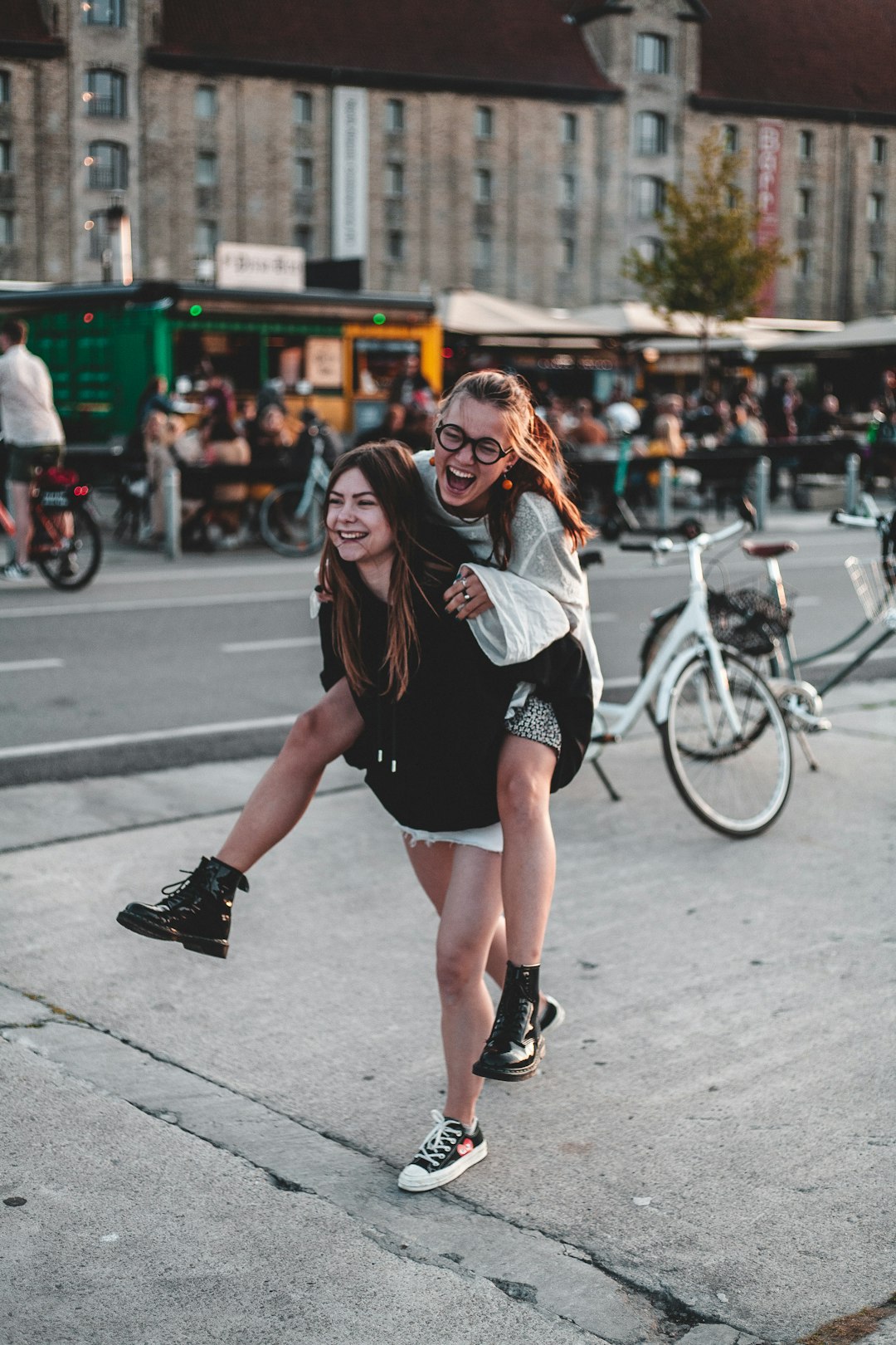 two women standing beside road