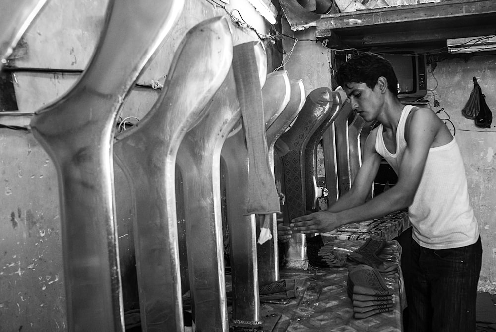 man in tank top holding box