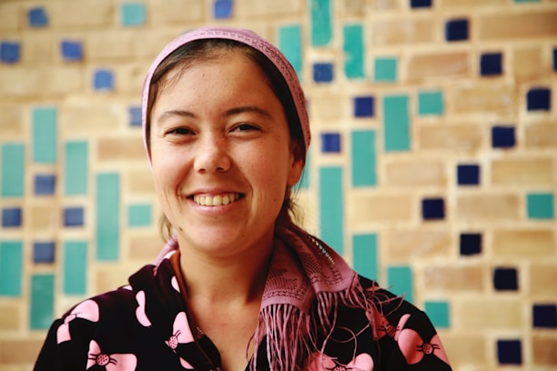Laila and her team smiling warmly in front of a traditional Moroccan riad.