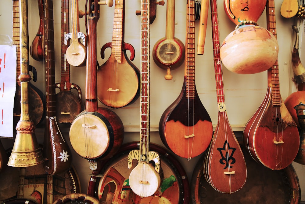 벽에 전시 된 다양한 갈색 나무 부족 현악기